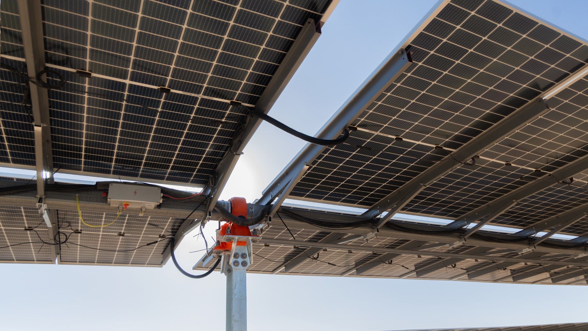 Close-up of a solar tracker drive and the underside of photovoltaic panels